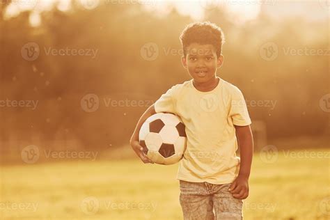 Young soccer player. African american kid have fun in the field at ...