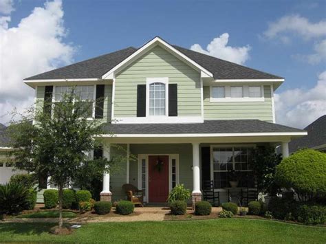 Green House, black shutters, white trim, white posts, bring on porch, red front door. | House ...