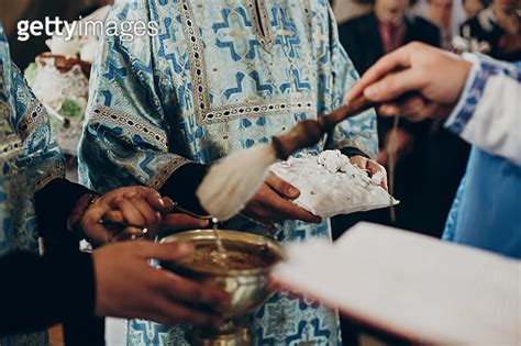 priest blessing wedding rings with holy water for wedding ceremony in ...