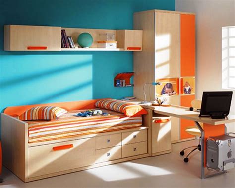 View of kids room with wooden bed and drawers - over head rack and shelf - study desk and bright ...