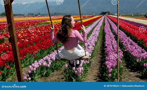 Young Attractive Blond Woman in White Summer Dress Swings on Chain ...