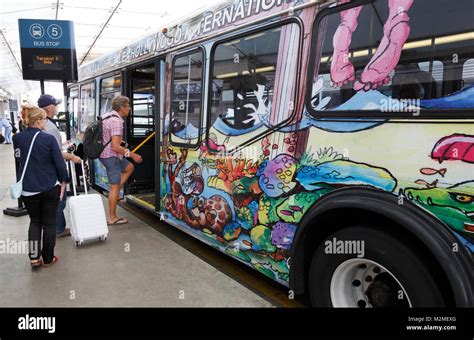 People passengers boarding colorful shuttle bus, Fort Lauderdale ...