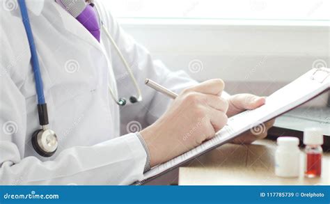 Doctor Writing a Prescription at Desk Stock Image - Image of male ...