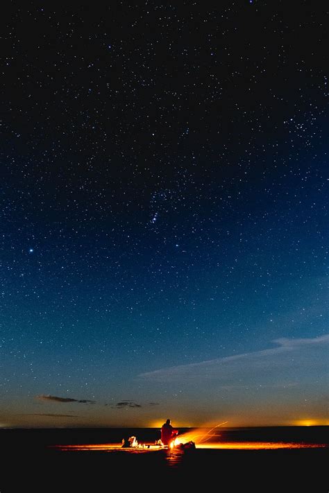 HD wallpaper: person sitting under starry night, sky, beach, camp, fire ...