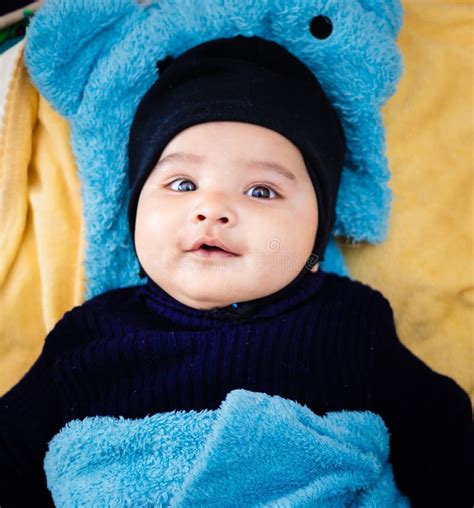 Infant Boy in Black Outfit Lying Cute Facial Expression at Indoor Stock Photo - Image of ...