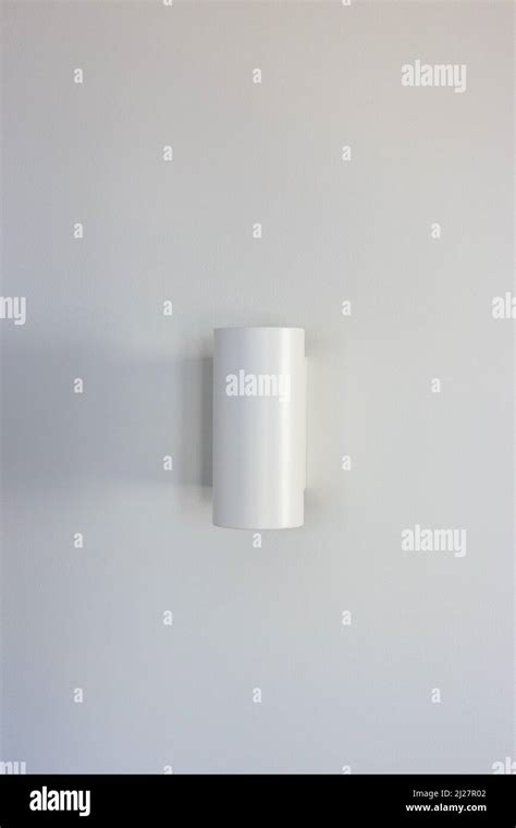 White wall lamp on a white wall Stock Photo - Alamy