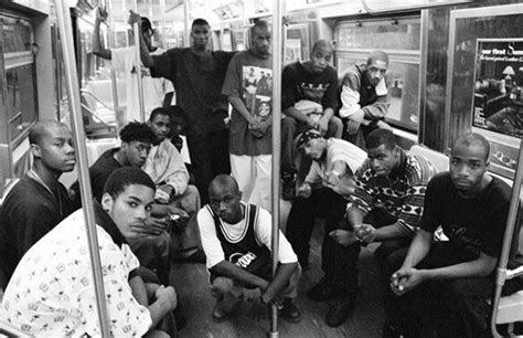 black and white photograph of people on subway train