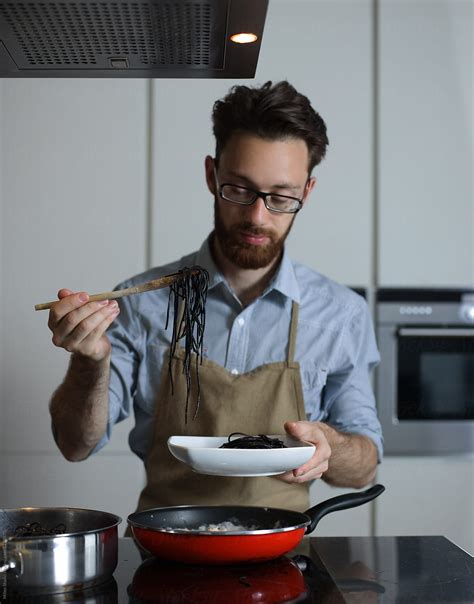 "Man Cooking At Home" by Stocksy Contributor "Milles Studio" - Stocksy