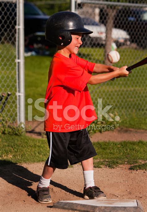 Boy Swings Bat At Baseball Stock Photo | Royalty-Free | FreeImages