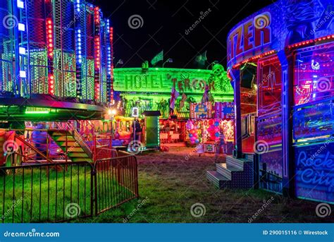 A Carnival Ride at Night Next To a Carousel Wheel and Carousel Rides ...