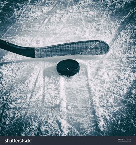 Hockey Stick And Puck On The Ice Rink. Stock Photo 221190736 : Shutterstock