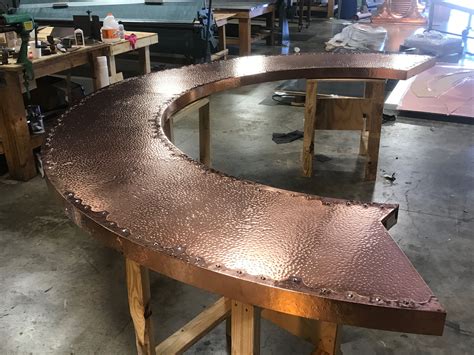 Hand-crafted custom copper bar top with a hand hammered finish, accented edging and ornamental ...