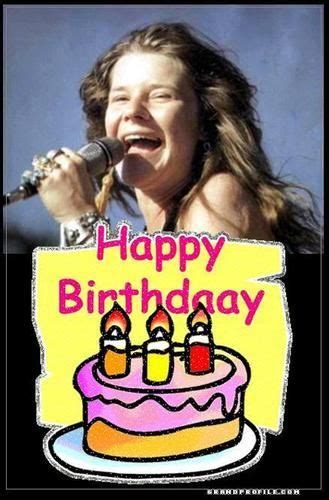 a woman singing into a microphone with a birthday cake on the plate in ...