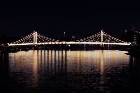 Iconic Albert Bridge At Night, Reflected In The River Thames