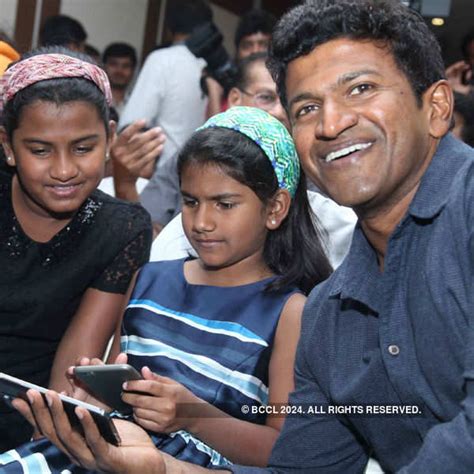 Puneeth Rajkumar with his daughters Driti and Vandita during the audio launch of movie Mythri ...