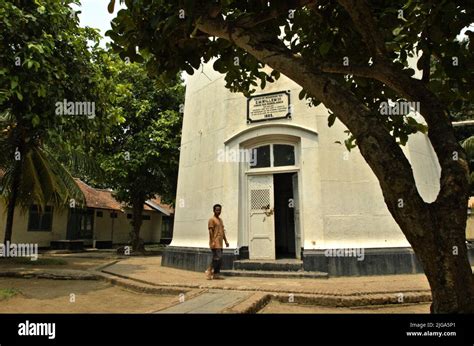 A man walking past the entrance of Cikoneng Lighthouse (Anyer Lighthouse) in Anyer, Serang ...