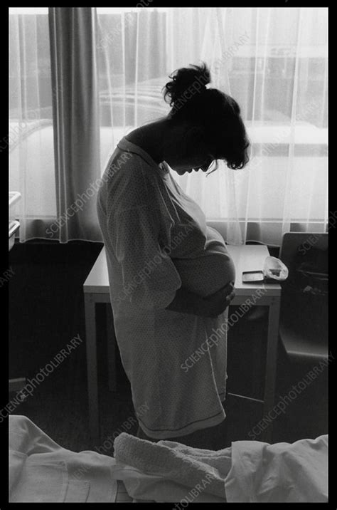 Pregnant woman in labour stands in a hospital ward - Stock Image - M810 ...