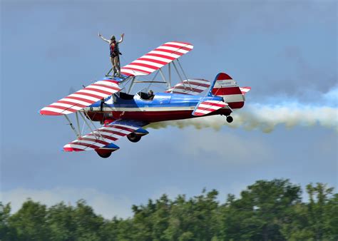 Female wing walker barnstorming the runway at the Oceania Air Show.