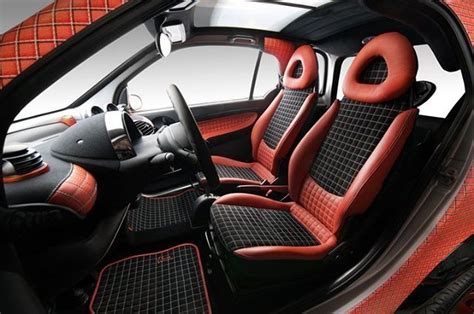 the interior of a car with red and black seats