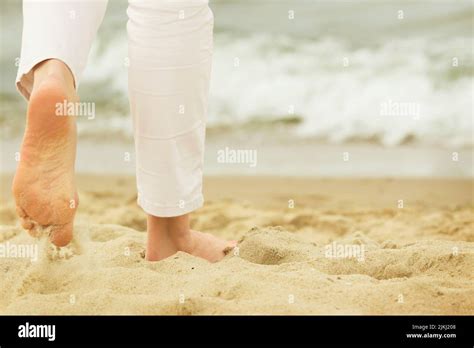 Walking barefoot on the beach Stock Photo - Alamy