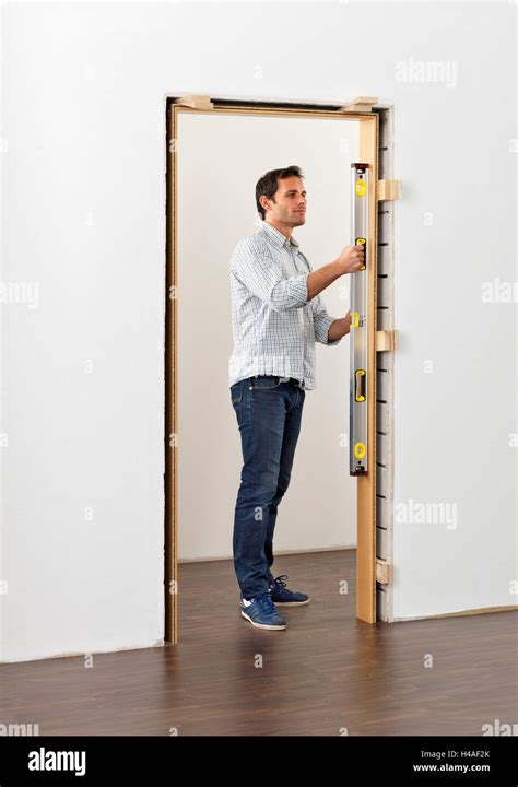 Door frame, installation, instructions, step 2, man Stock Photo - Alamy