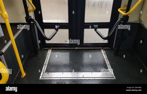 Bus door with yellow handles, interior view. The mechanism for opening ...