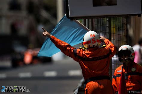 Marshal with a blue flag, 2017 · RaceFans