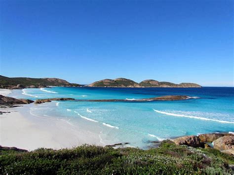 the beach is clear and blue with white sand