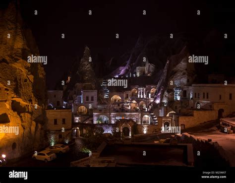 Night scene of the Uchisar Castle in Cappadocia. Illuminated view of famous Uchisar village ...