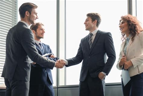 Premium Photo | Business people shaking hands finishing up a meeting