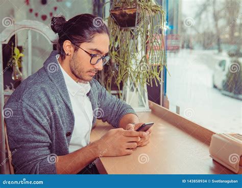 Staying Connected. Happy Young Man Looking at His Mobile Phone Stock ...