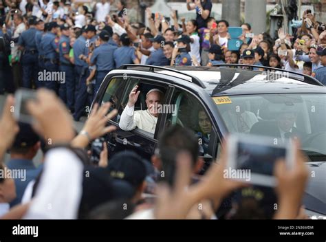 FILE - In this Friday, Jan. 16, 2015 file photo, Pope Francis waves to Filipinos after mass at ...