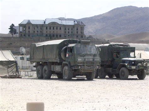 Camp Julien | Vehicles with Queen's Palace in background | trec_lit | Flickr