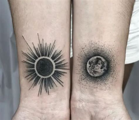 two sun and moon tattoos on both wrists, one is black and the other is white