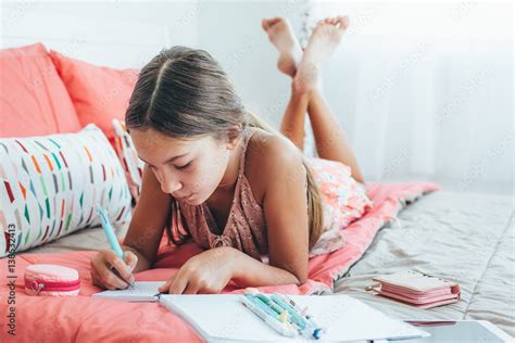 Pre teen girl writing diary Stock Photo | Adobe Stock