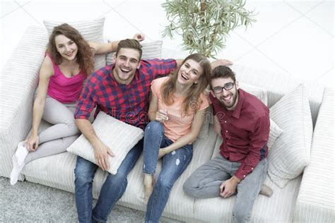 Four Happy Friends Laughing while Sitting on the Couch Stock Photo - Image of laugh, clothing ...