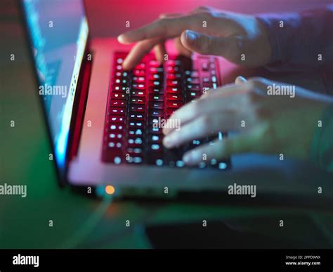 Hacker typing on illuminated laptop keyboard at office Stock Photo - Alamy