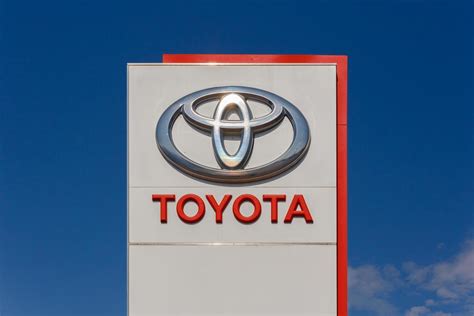 Toyota logo on promotional stand at sunny day - Toyota Motor ...