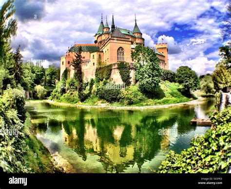 Historic Bojnice Castle, one of Slovakia's top tourist attractions, reflected in its moat and ...