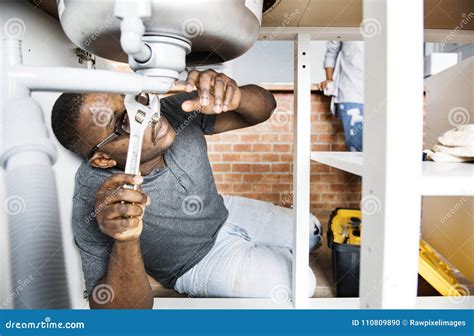 Plumber Man Fixing Kitchen Sink Stock Photo - Image of america, people: 110809890