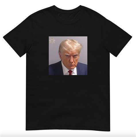 Trump’s Mug Shot Merch Includes Campy T-Shirts, Mugs, & Buttons