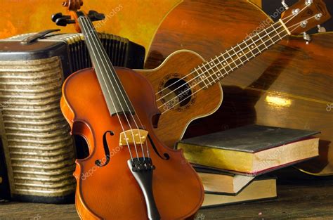 Violin, guitar and books on still-life wooden background — Stock Photo © SuradechK #87161872