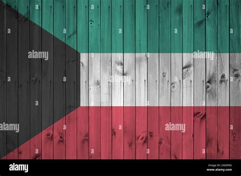 Kuwait flag depicted in bright paint colors on old wooden wall close up ...