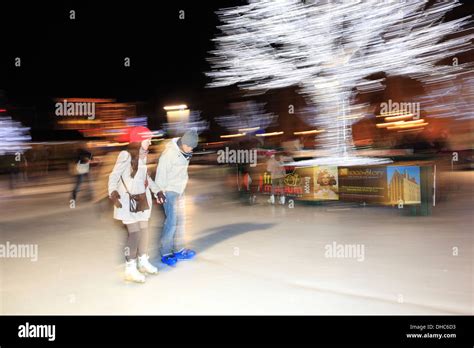 Panned camera effect on People skating on the Christmas Ice rink ...