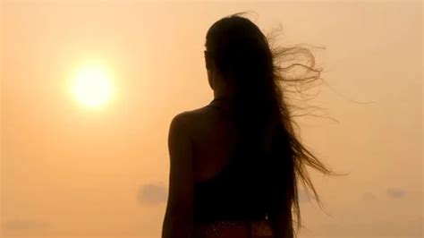 Silhouette of a girl with long hair enjo... | Stock Video | Pond5