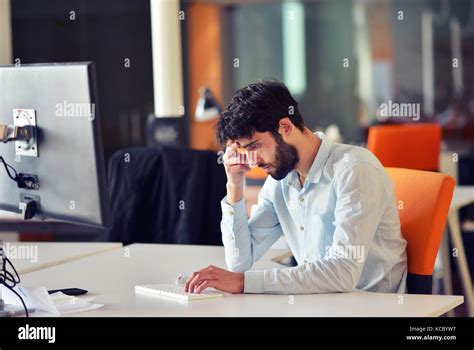 young business man working on desktop computer at his desk in modern ...