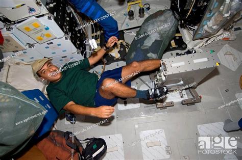 - Astronaut Jose Hernandez, STS-128 mission specialist, works out on ...