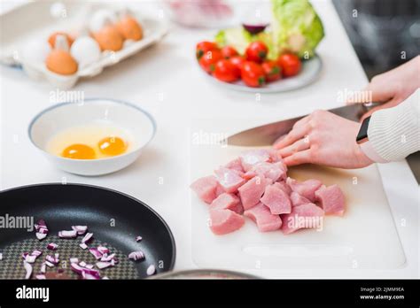 Cooking table with hands cutting meat Stock Photo - Alamy