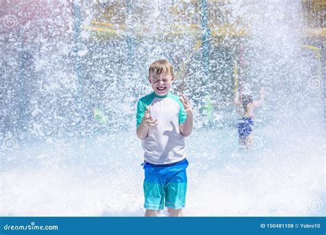 Young Boy Getting Soaking Wet while at an Outdoor Water Park Stock Photo - Image of eyes, face ...