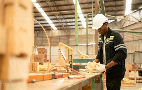 Young man worker work in a woodworking factory, Working with wood ...